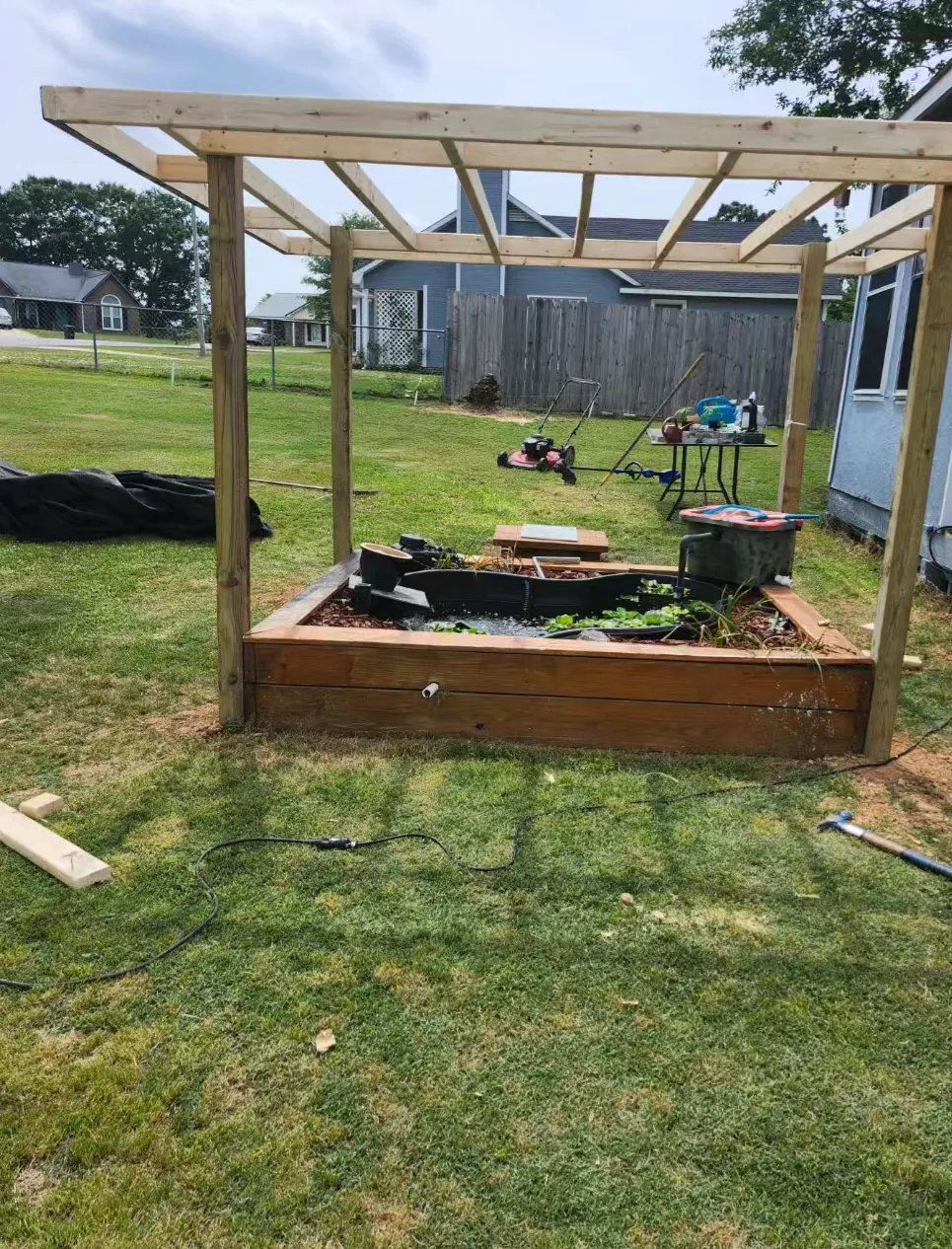 Cedar pergola framed over a raised garden bed