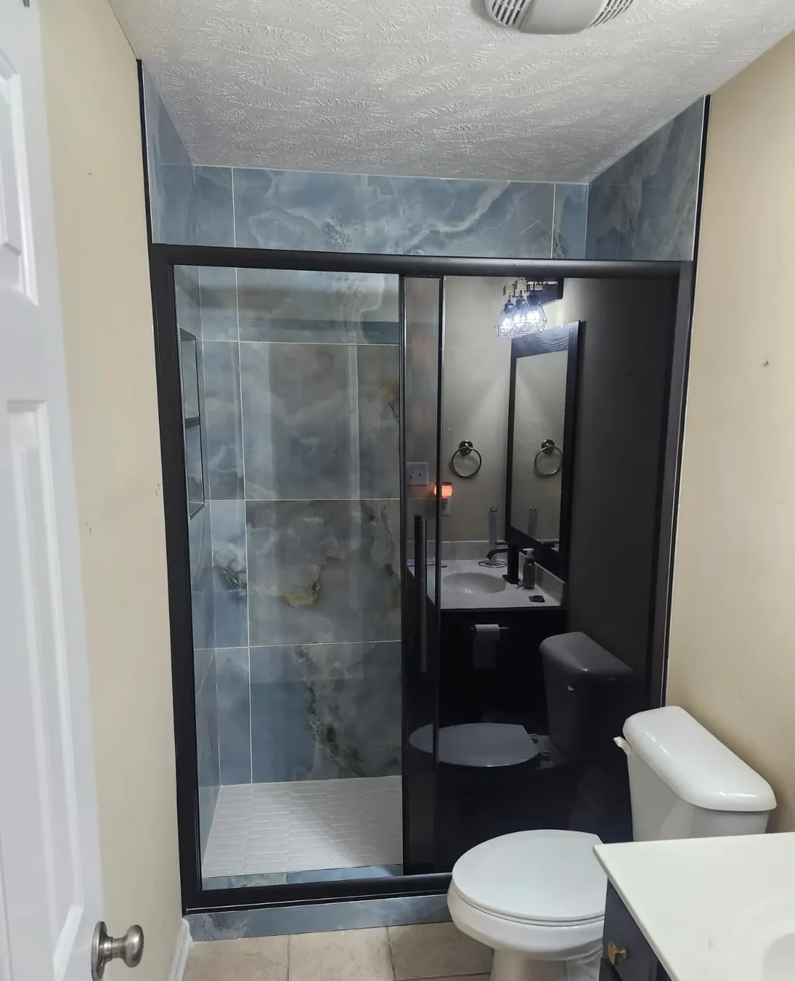 Framed glass shower enclosure in a finished bathroom
