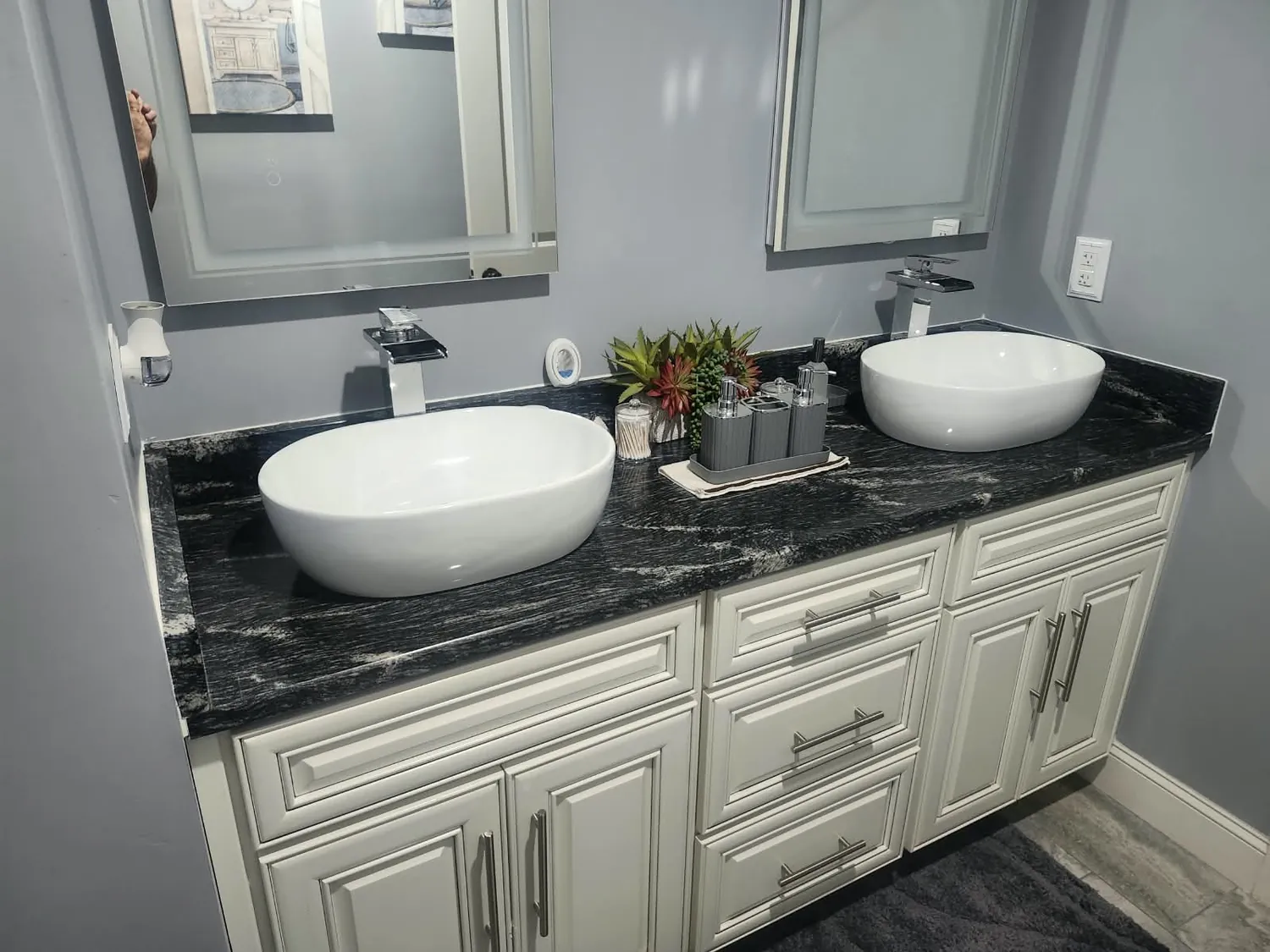 Double vanity with vessel sinks on a black granite top