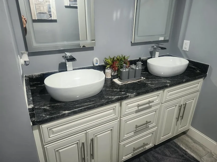 Double vanity with vessel sinks on a black granite top