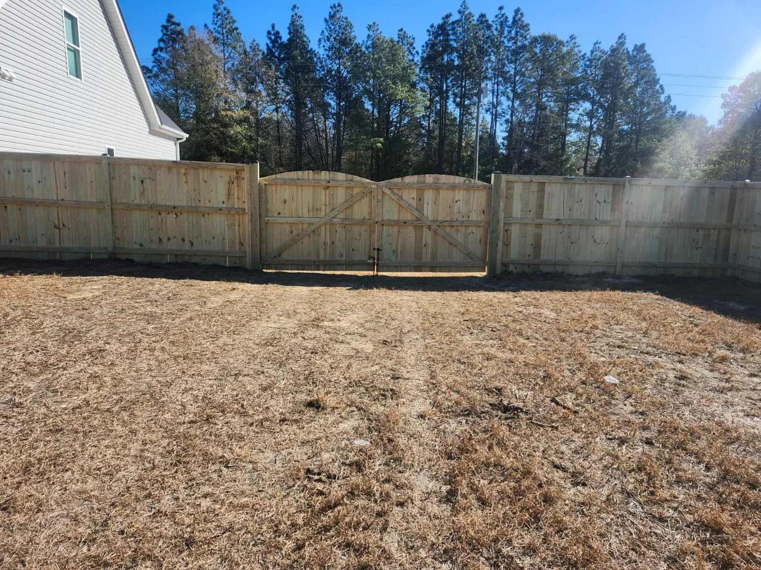 Wooden privacy fence around a suburban back yard