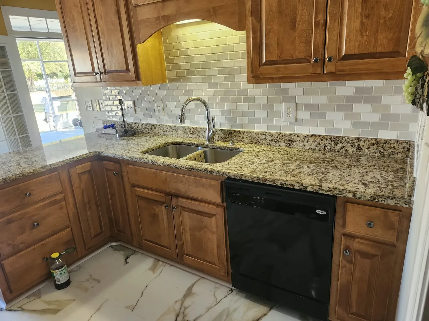 Kitchen with granite counters, tile backsplash and stained cabinets
